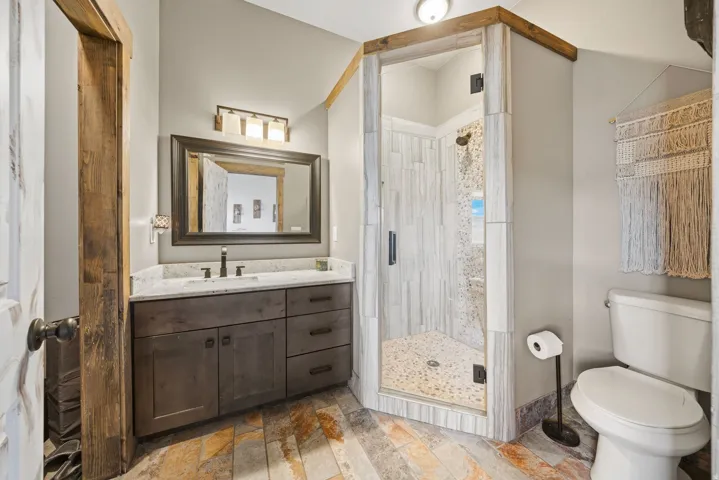 Full bath with a stall shower and vanity