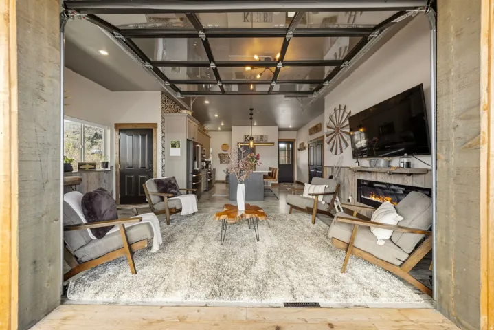 Living area with a glass covered fireplace and recessed lighting
