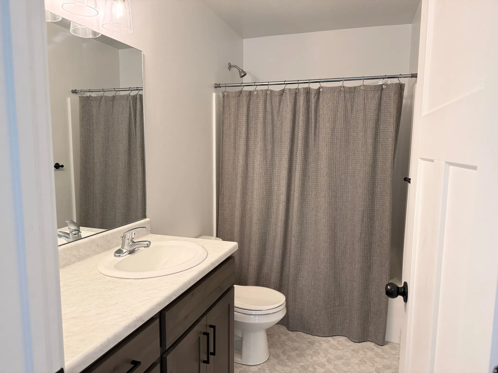 Full bath featuring vanity and a shower with curtain