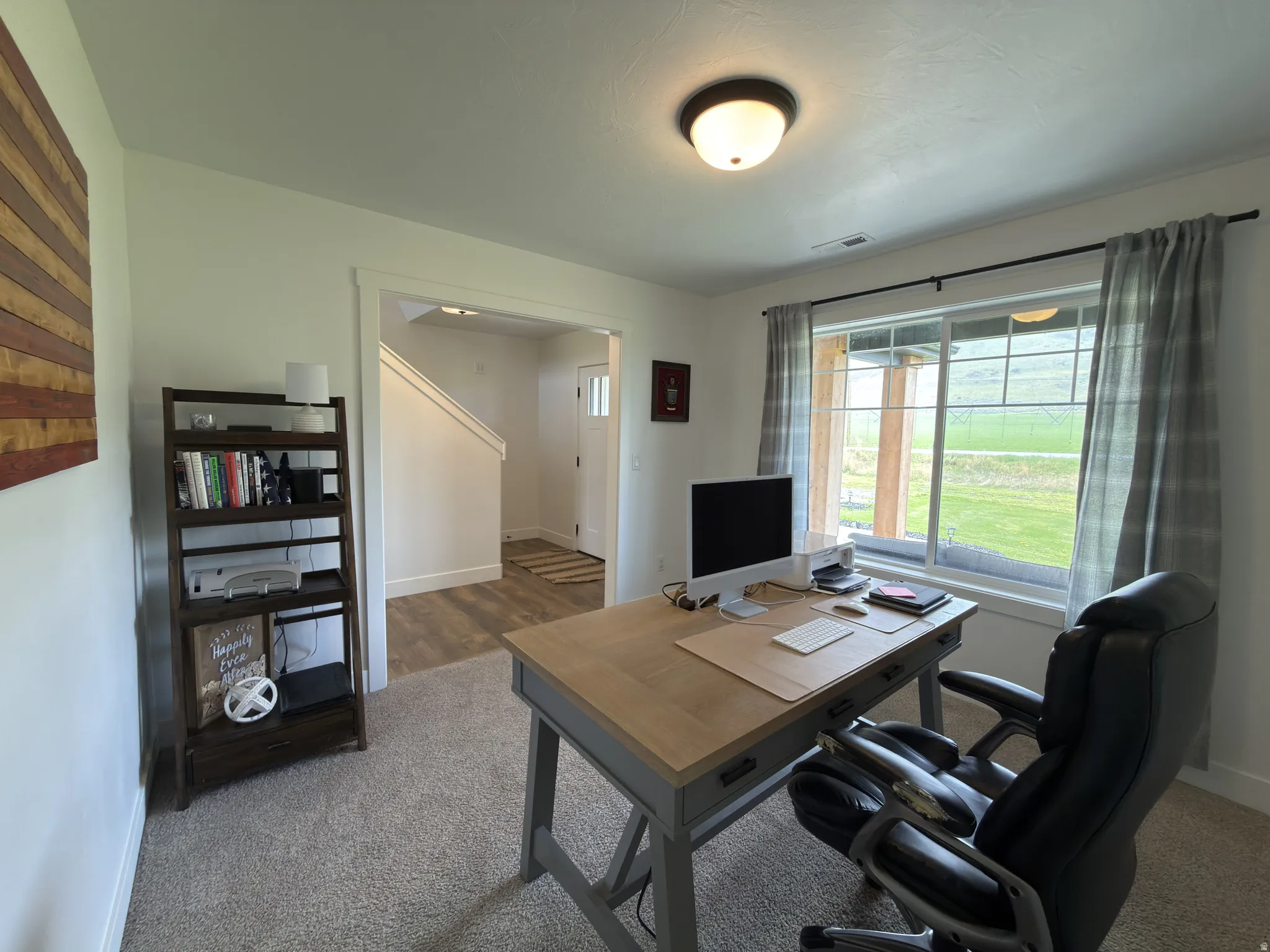 Home office featuring dark colored carpet