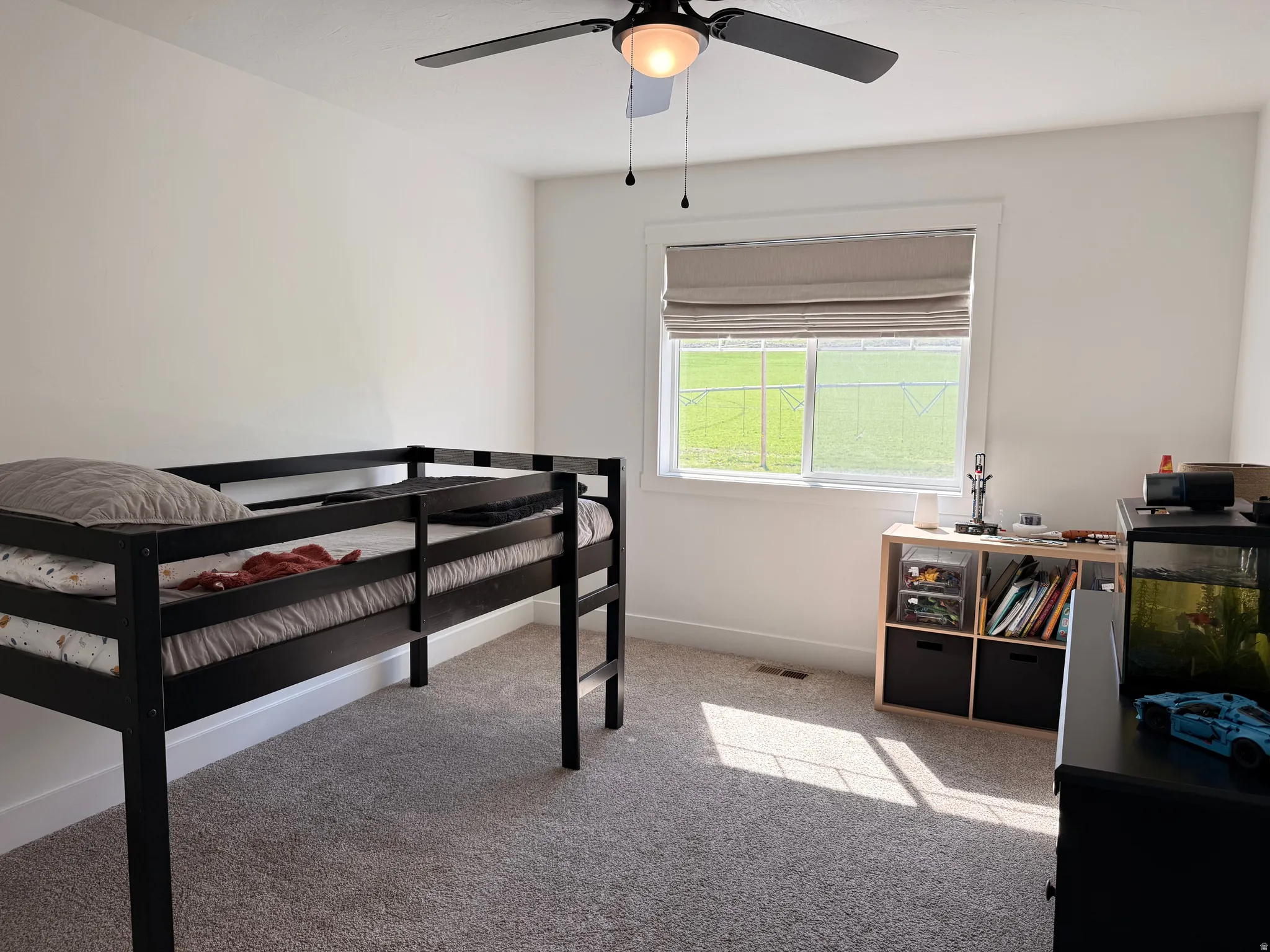 Bedroom with light carpet and ceiling fan