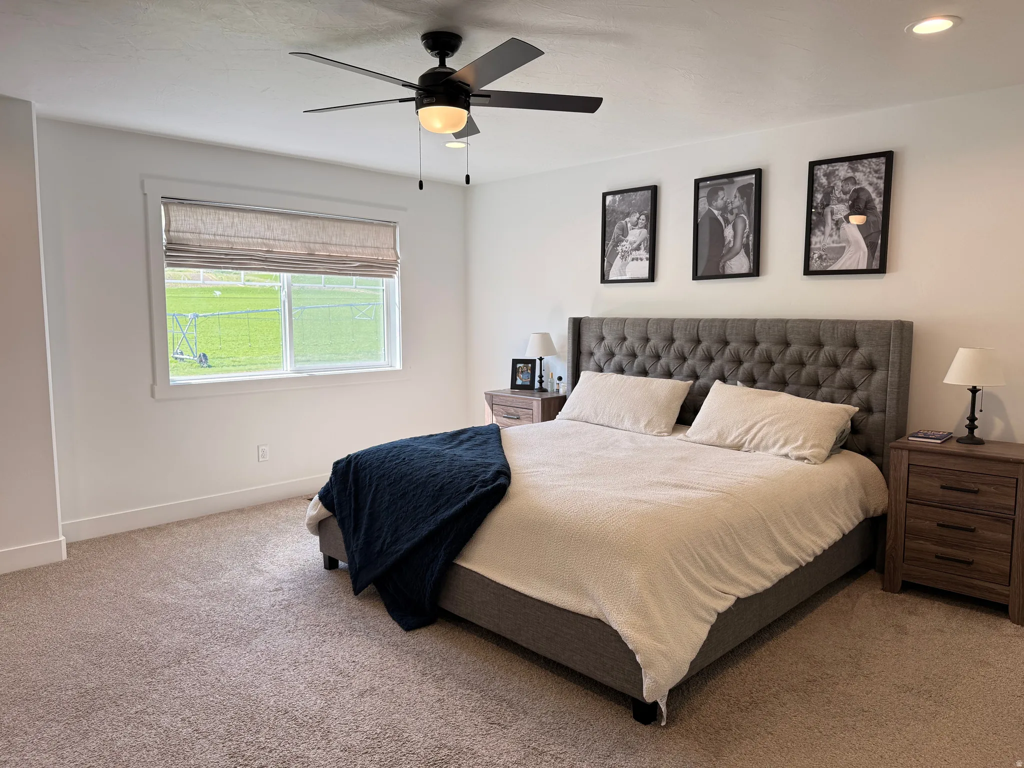 Bedroom with light carpet, a ceiling fan, and recessed lighting