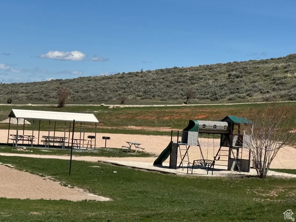 View of home's community playground and groupl even area