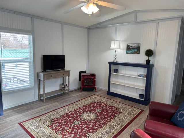 Living area featuring ceiling fan and light wood finished floors