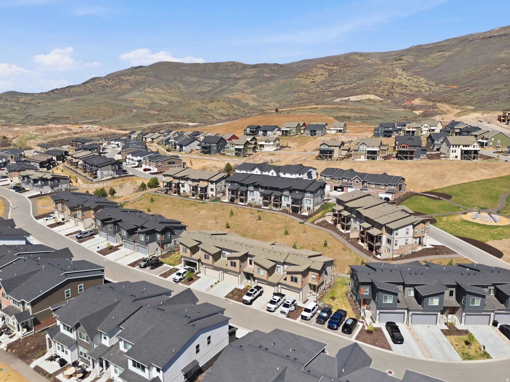 Aerial overview of property's location featuring mountains and nearby suburban area