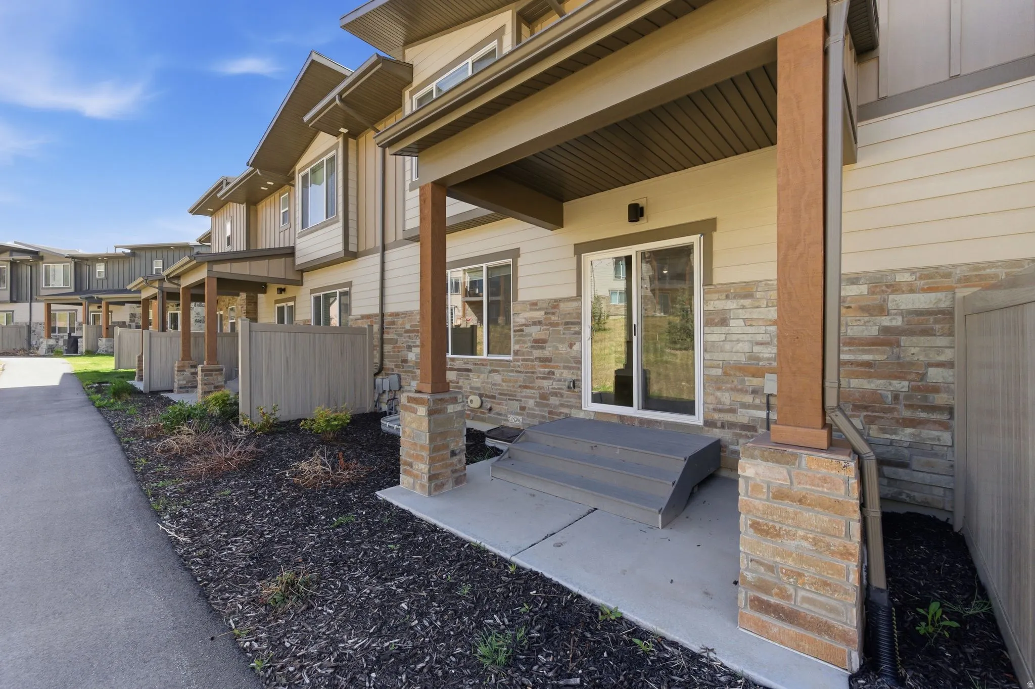 Entrance to property with stone siding, a residential view, and a porch