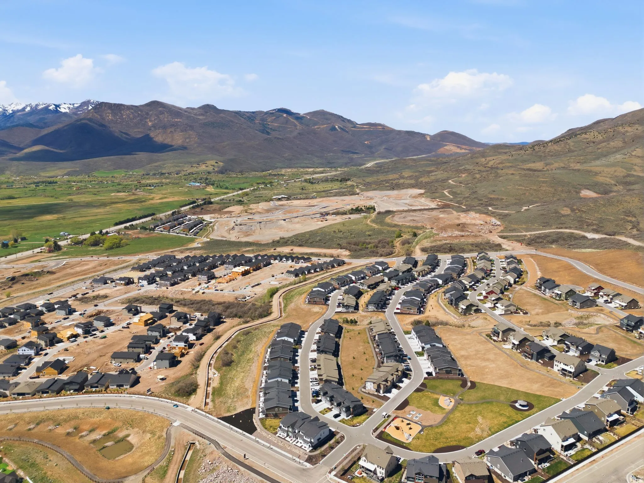 Aerial perspective of suburban area featuring a mountain backdrop