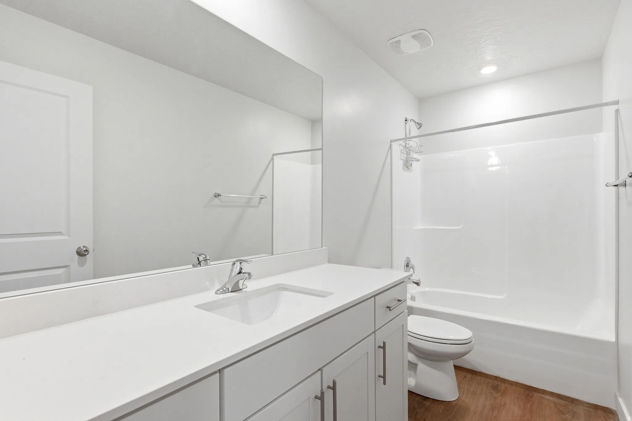 Full bath with vanity, dark wood-style flooring, and  shower combination