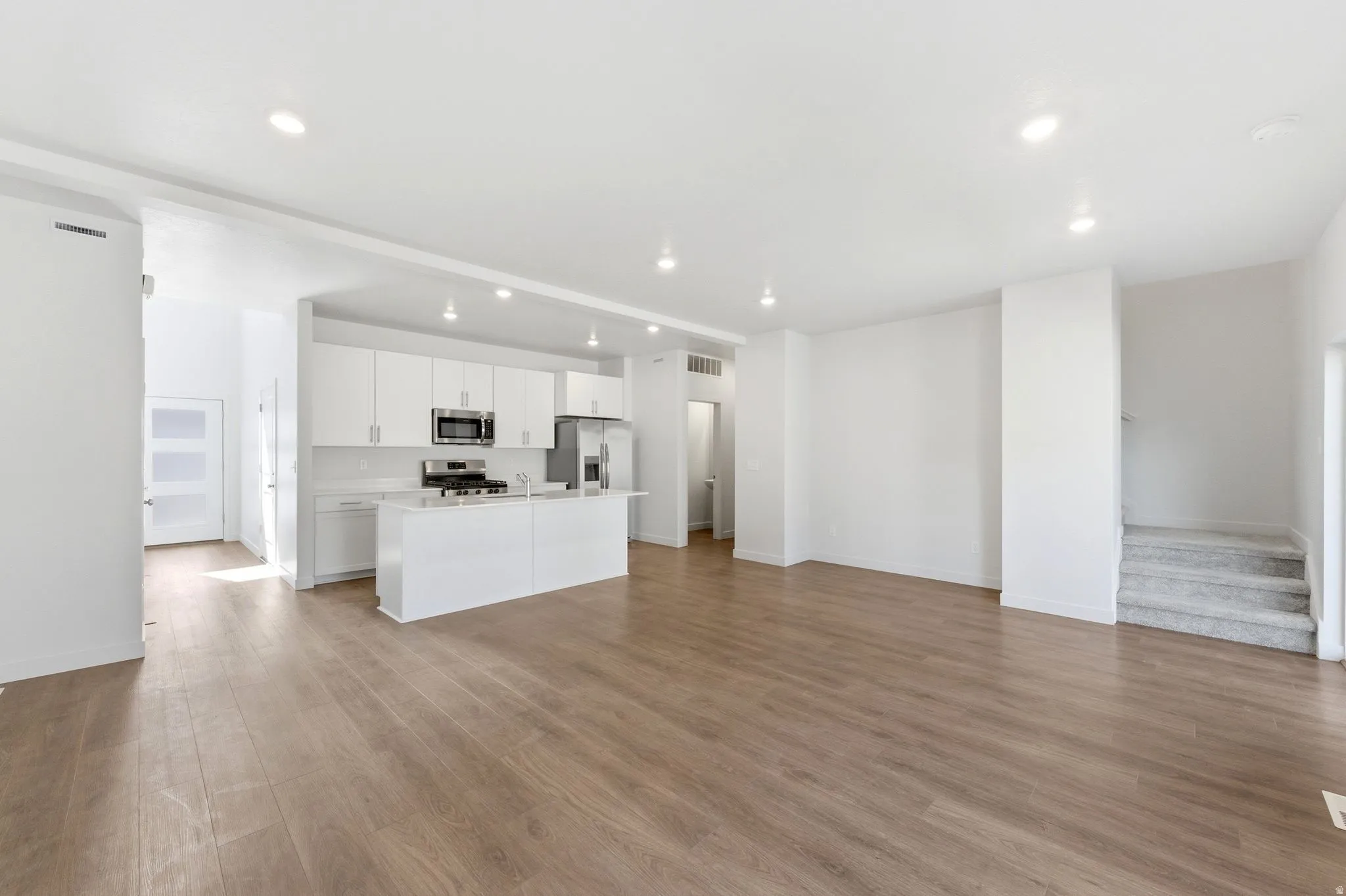 Unfurnished living room featuring light wood-style floors and recessed lighting