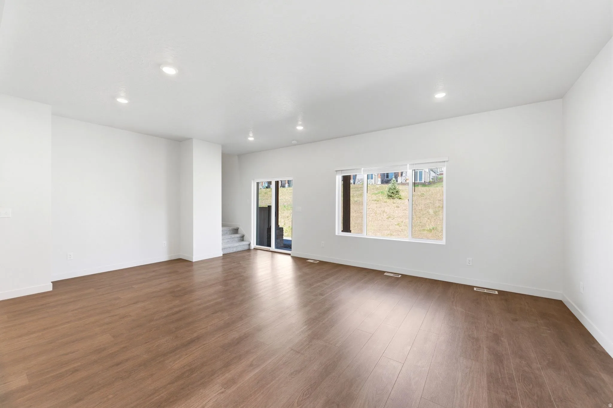 Unfurnished room featuring dark wood finished floors and recessed lighting