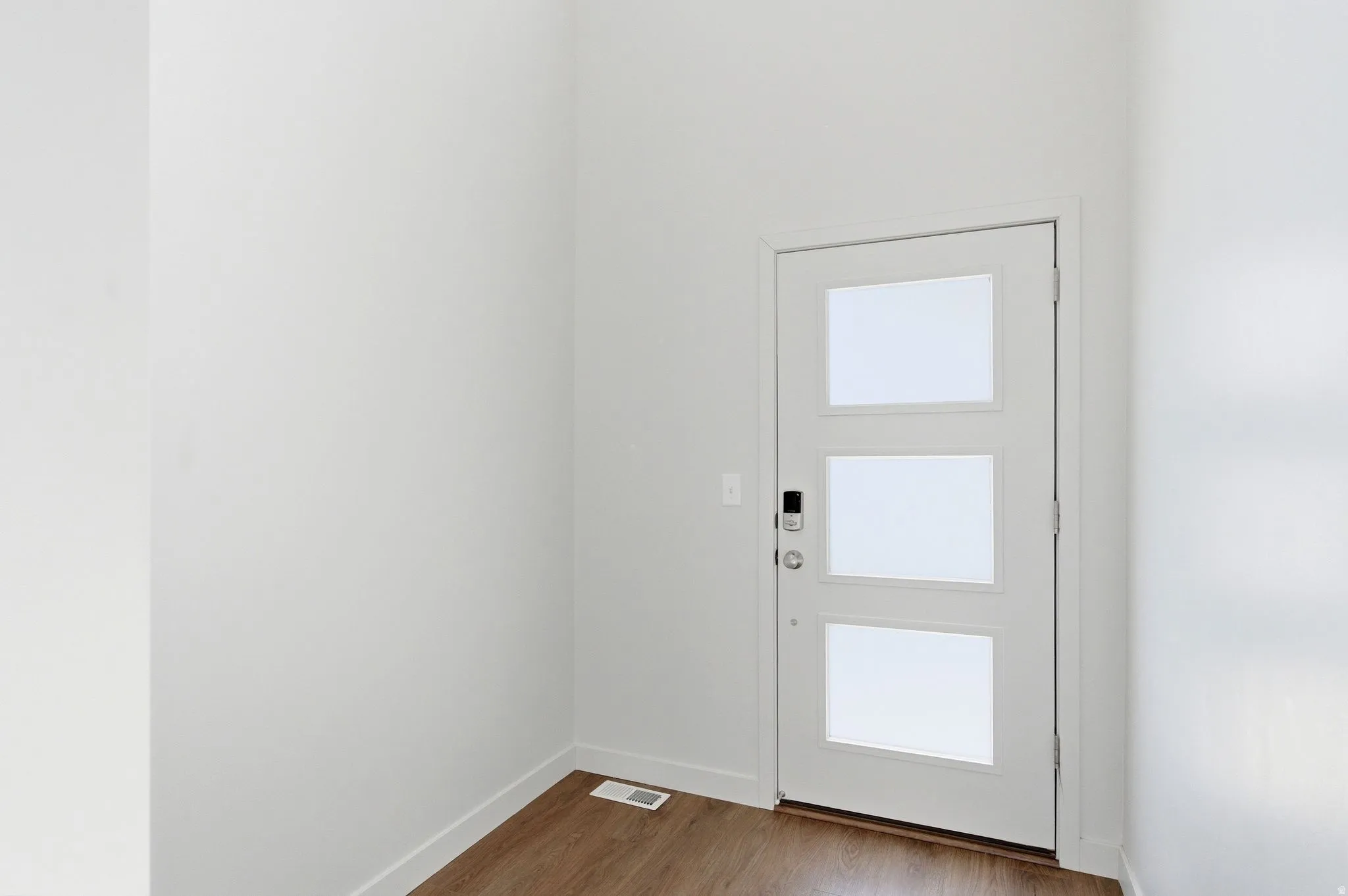 Entryway featuring wood finished floors and baseboards