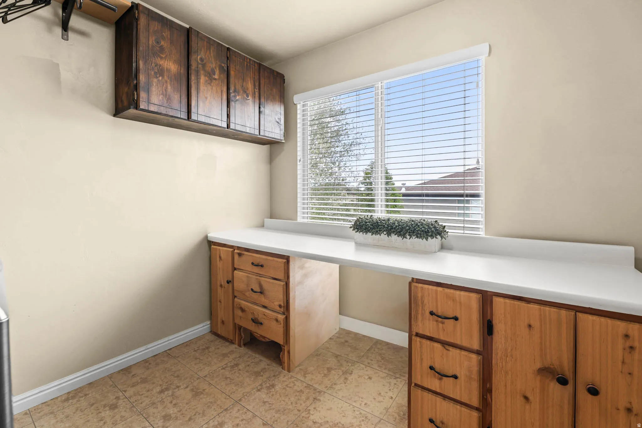 Craft room, storage space, kids desk with light tile patterned floors