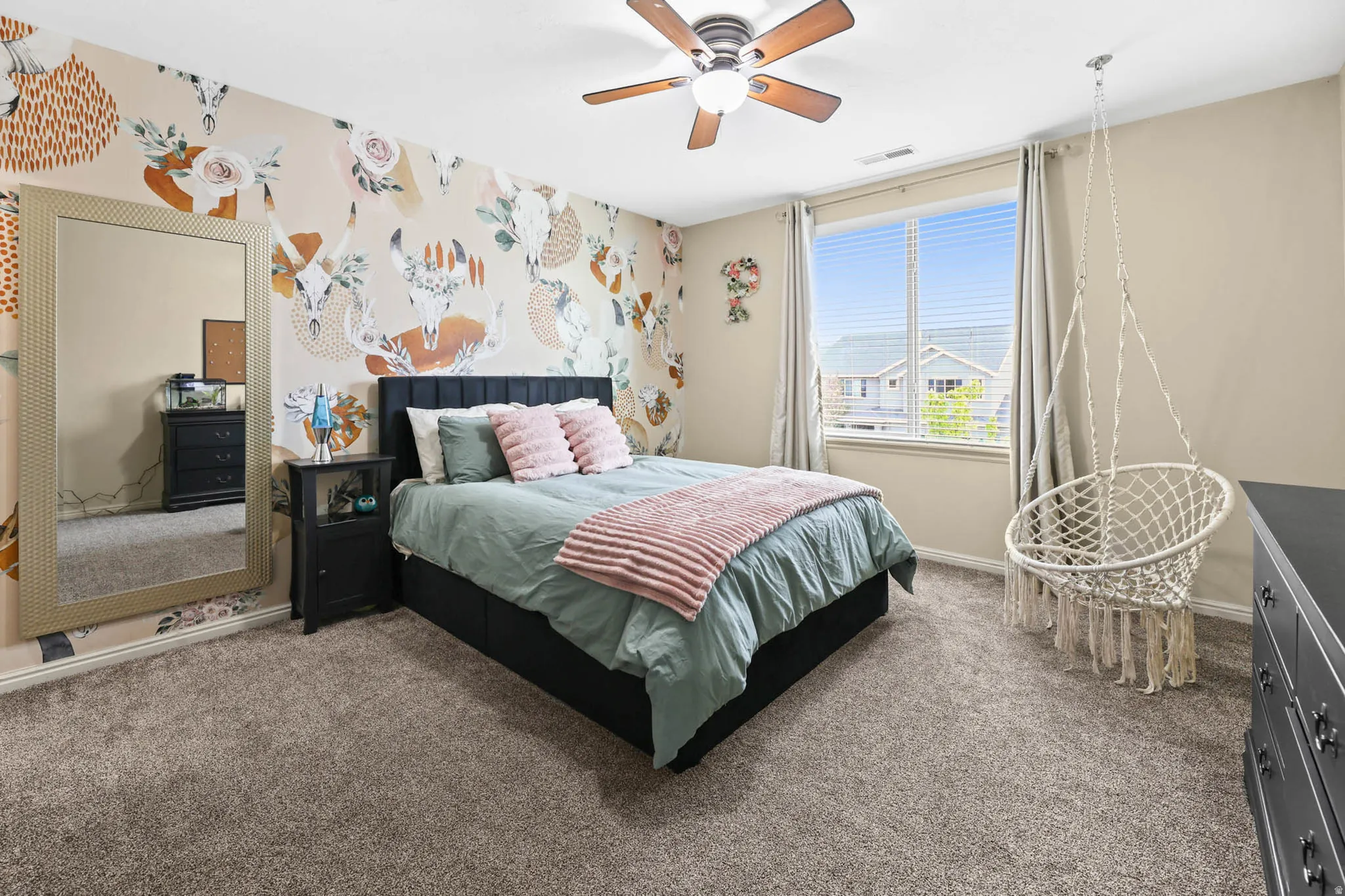 Bedroom featuring carpet flooring, wallpapered walls, and ceiling fan