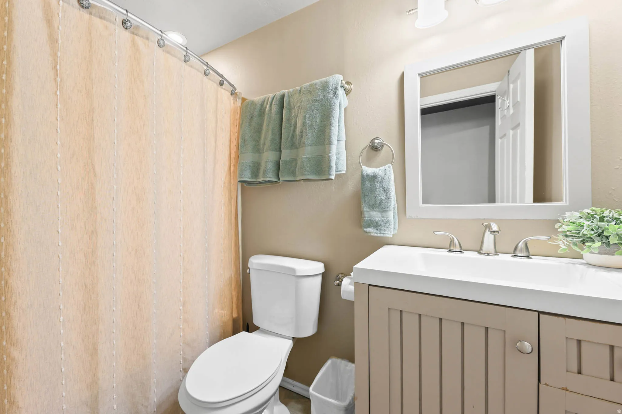 Full bath featuring vanity and curtained shower