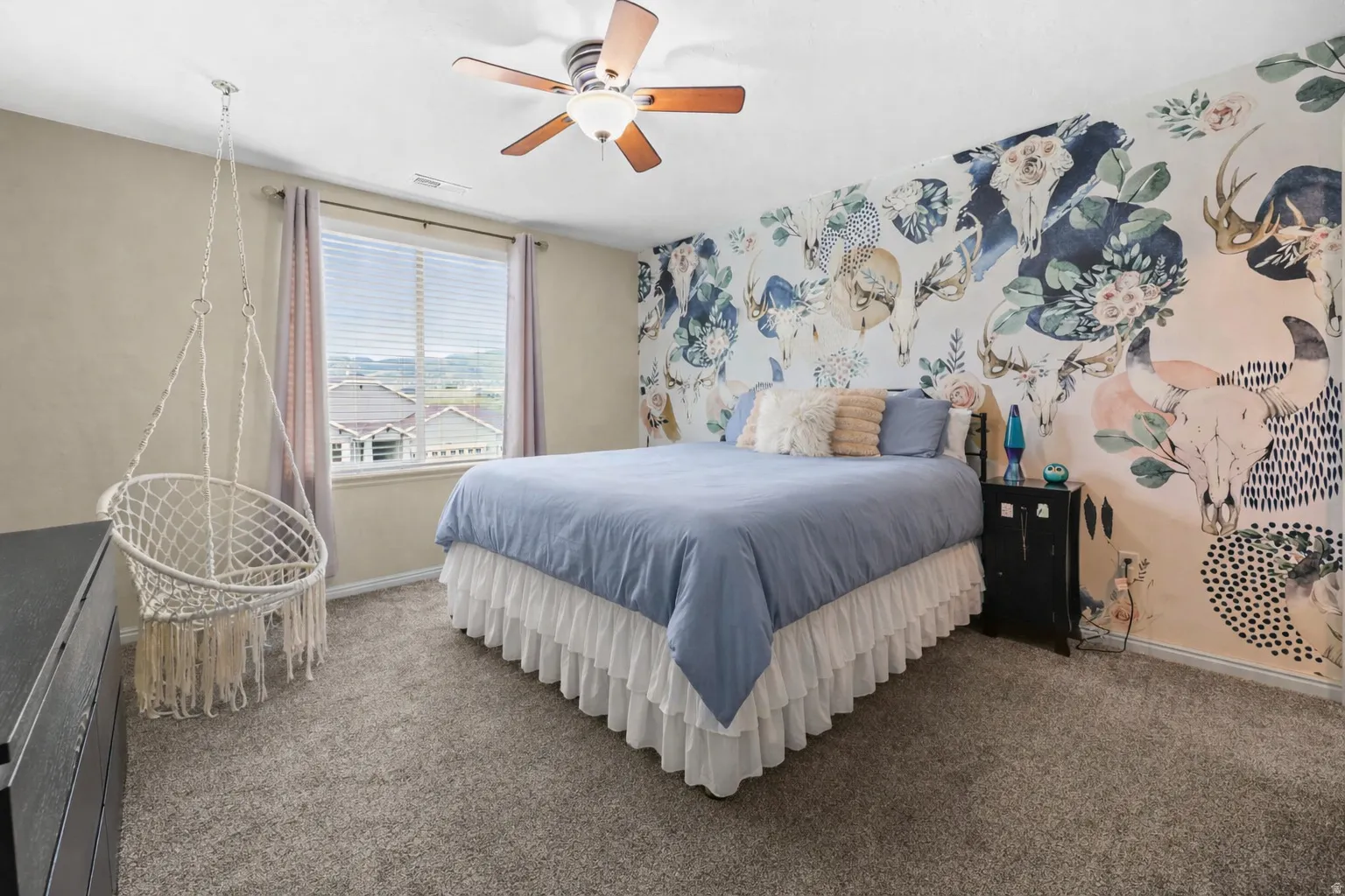 Carpeted bedroom featuring ceiling fan and baseboards