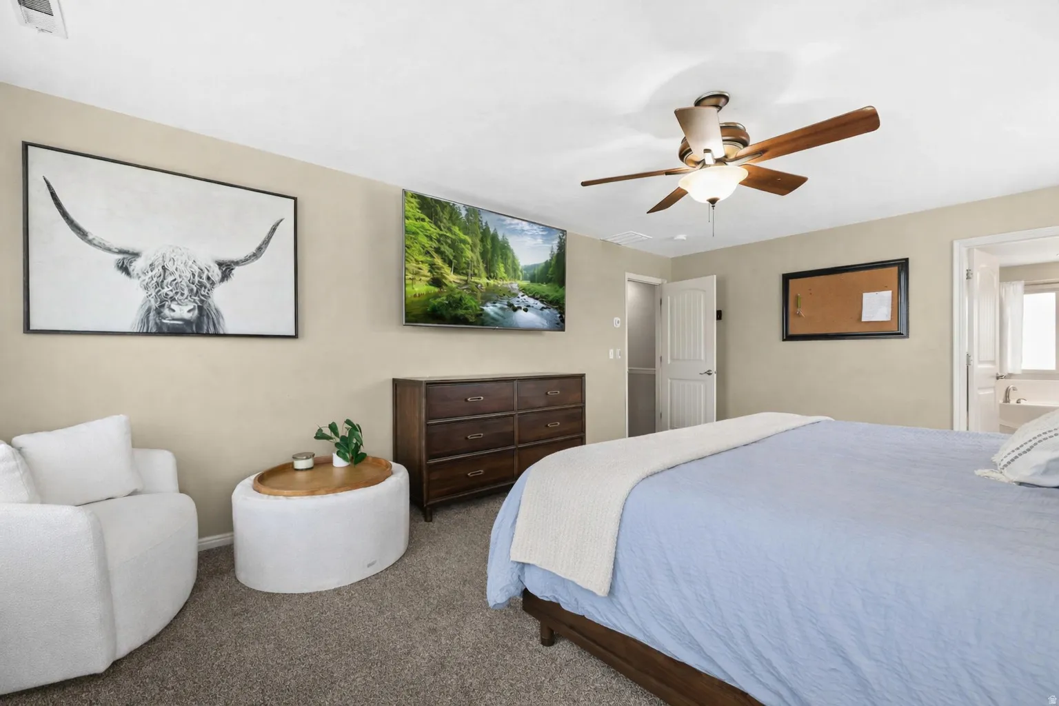 Carpeted bedroom with ceiling fan