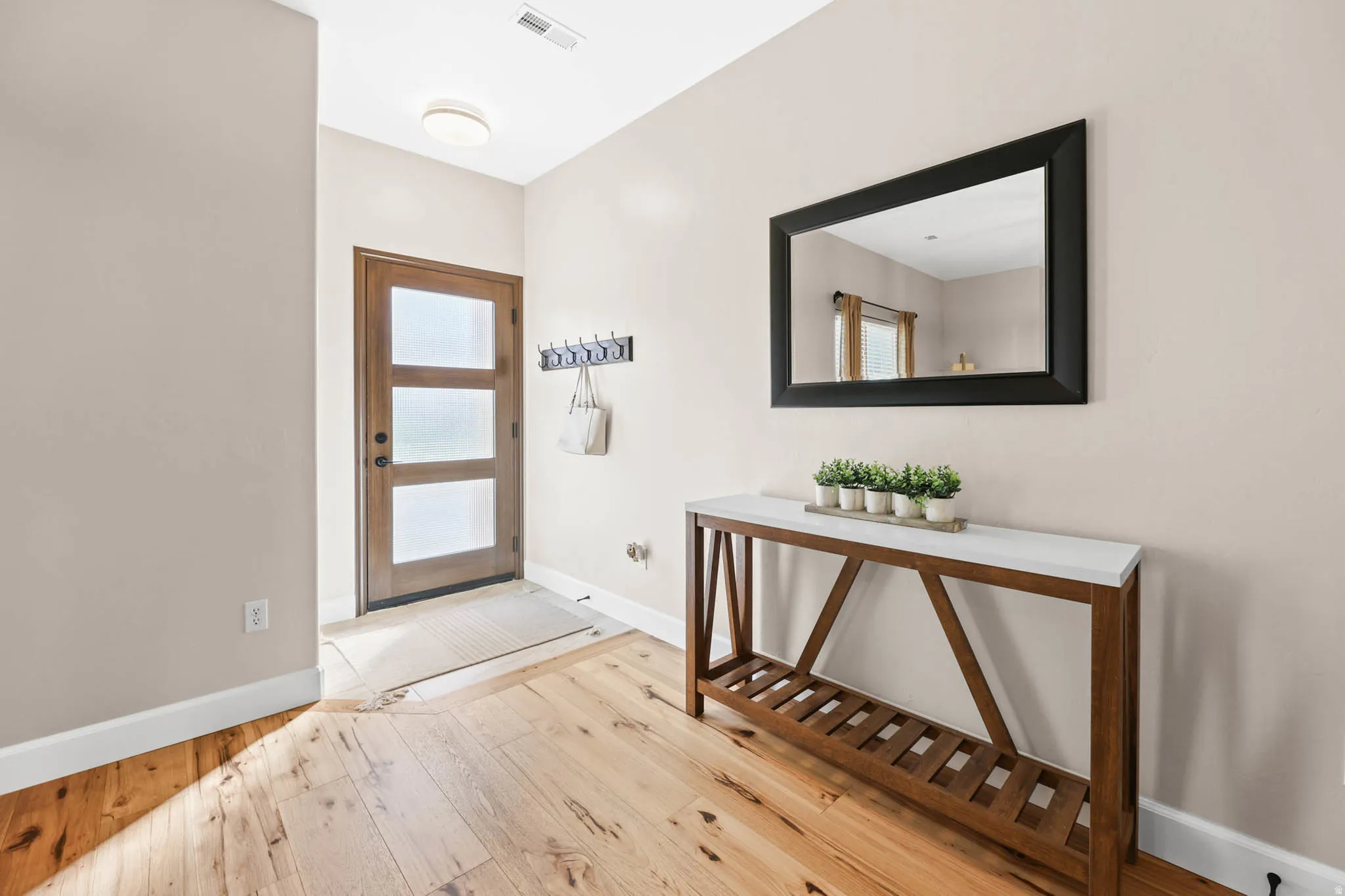 Foyer entrance featuring engineered hard wood floors