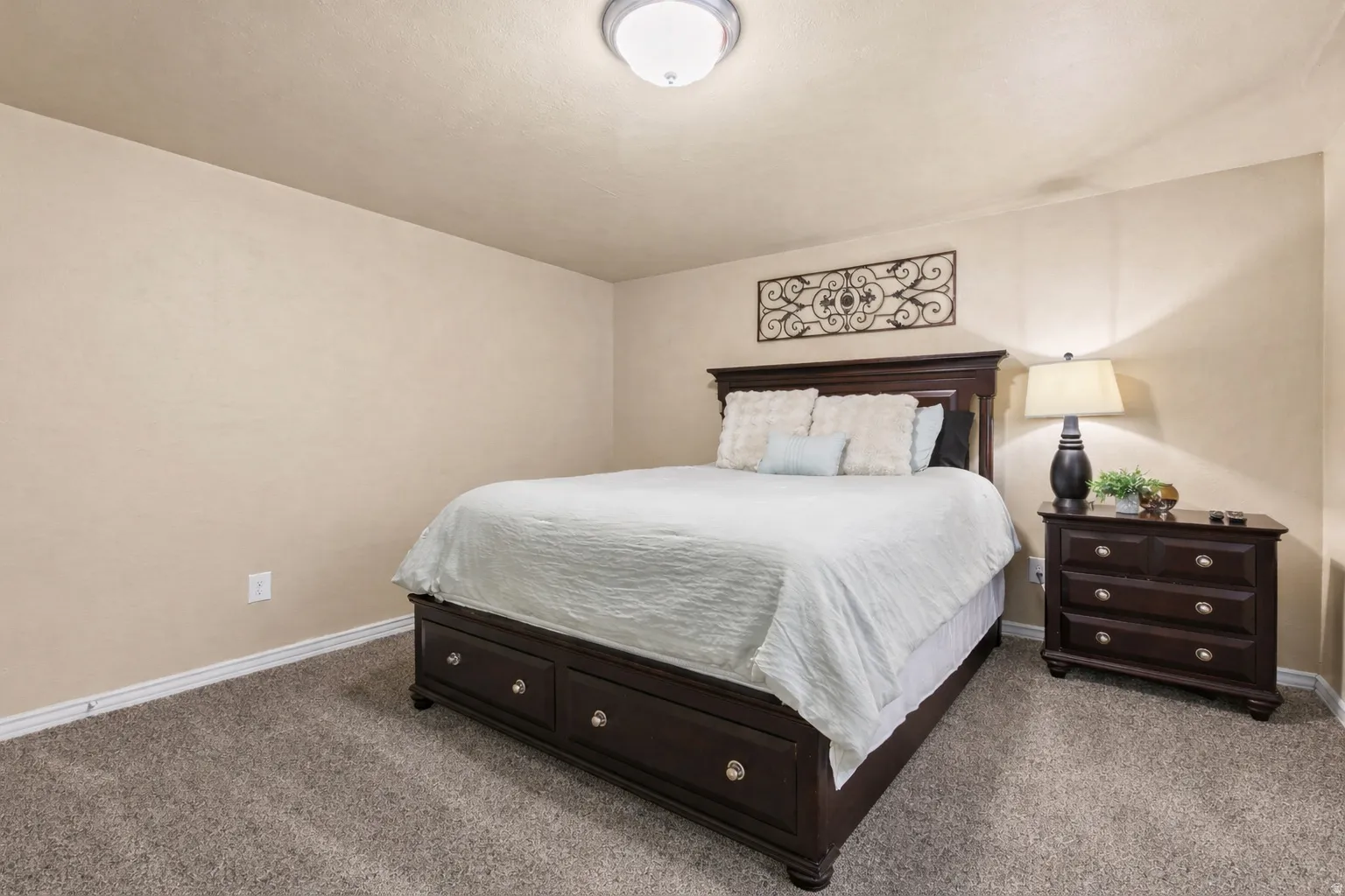 Carpeted bedroom featuring baseboards