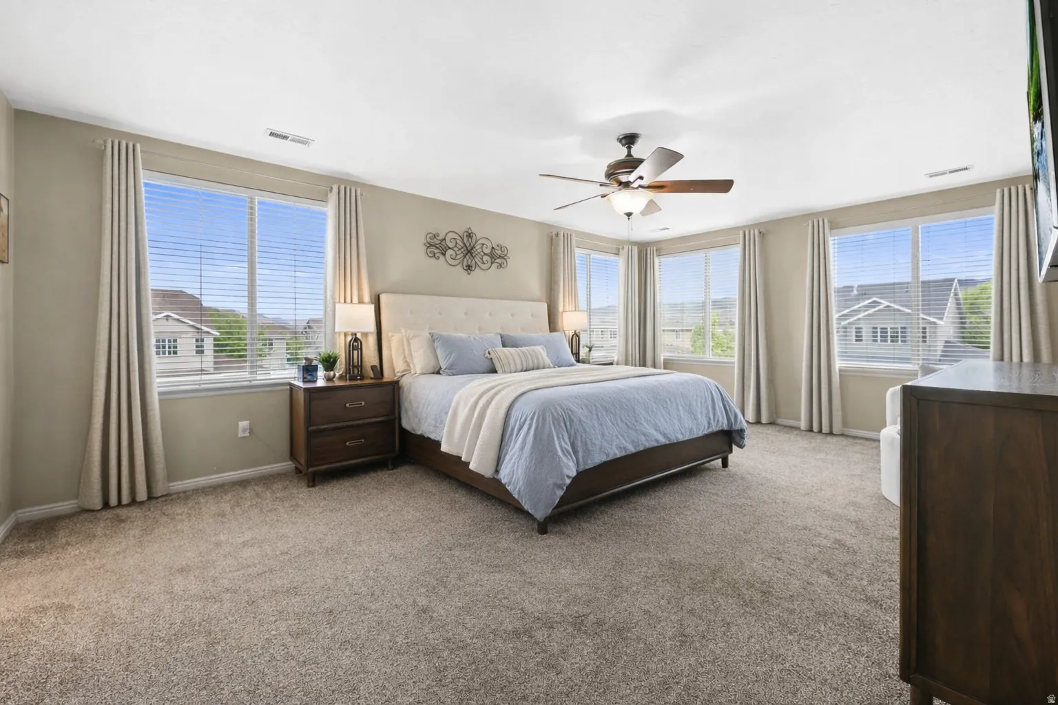 Owners Suite, bedroom with ceiling fan and carpet floors