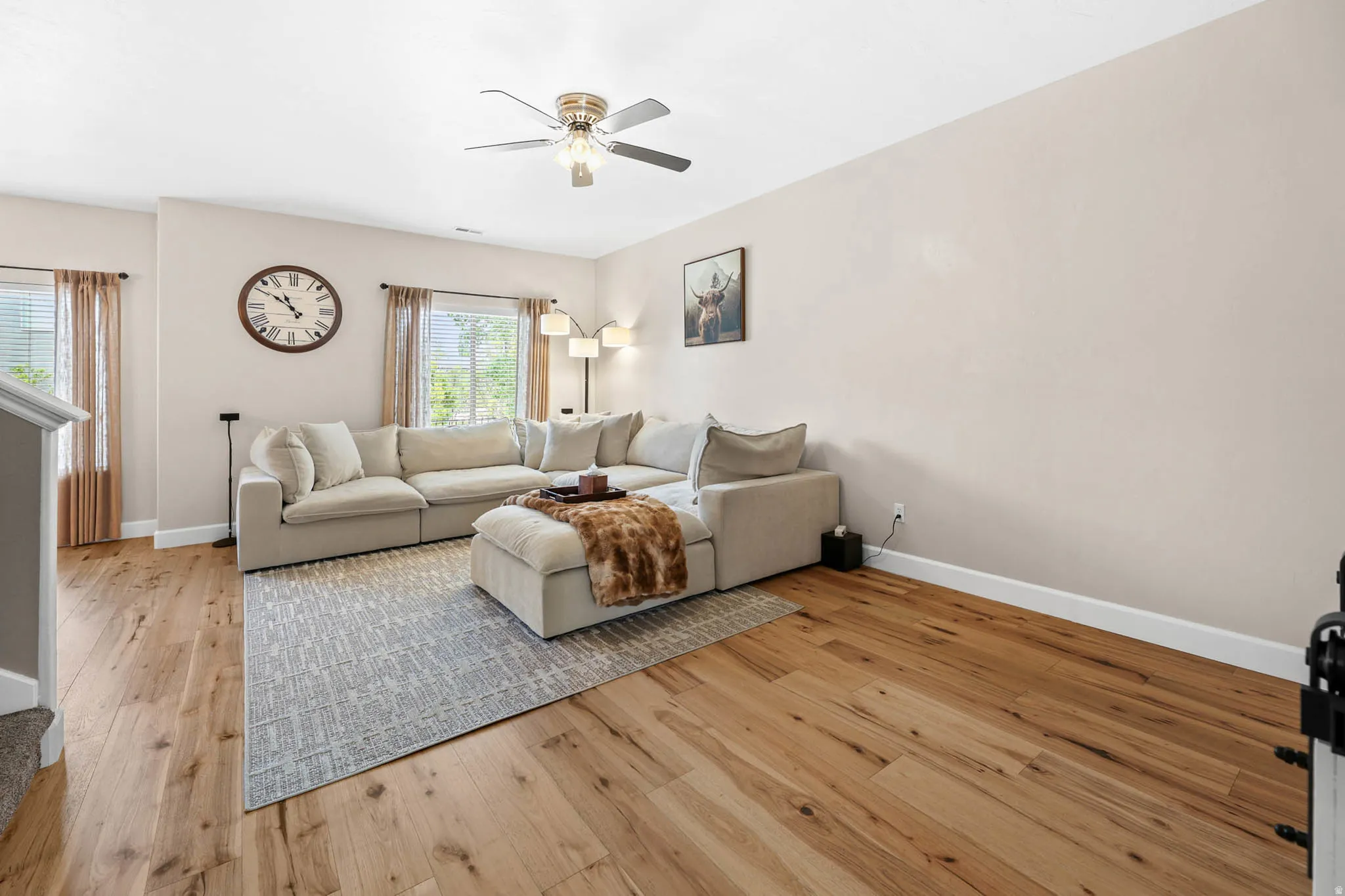 Living area featuring engineered hardwood finished floors and ceiling fan