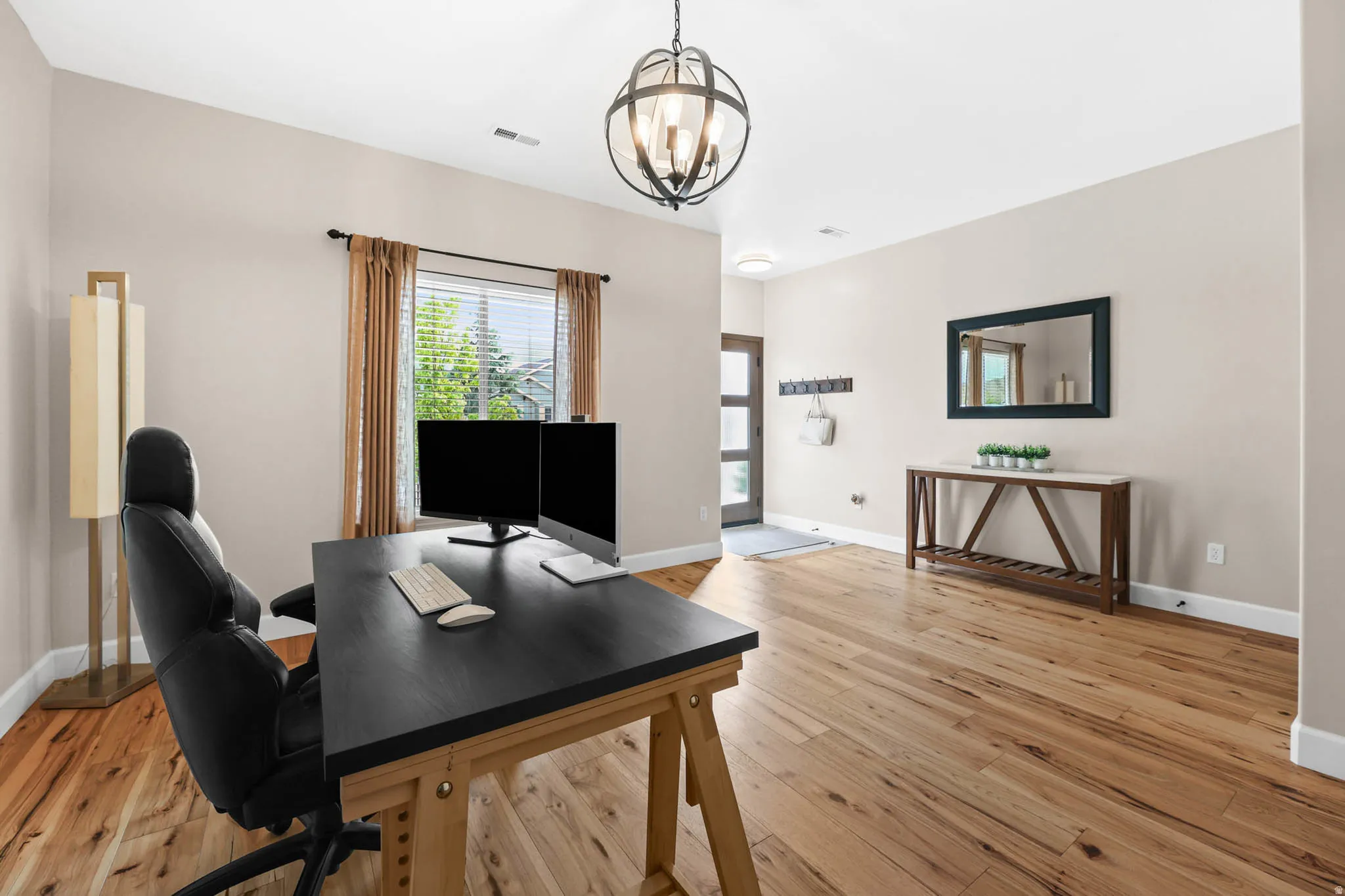 Office area or formal living room area with engineered hardwood flooring and hanging lights