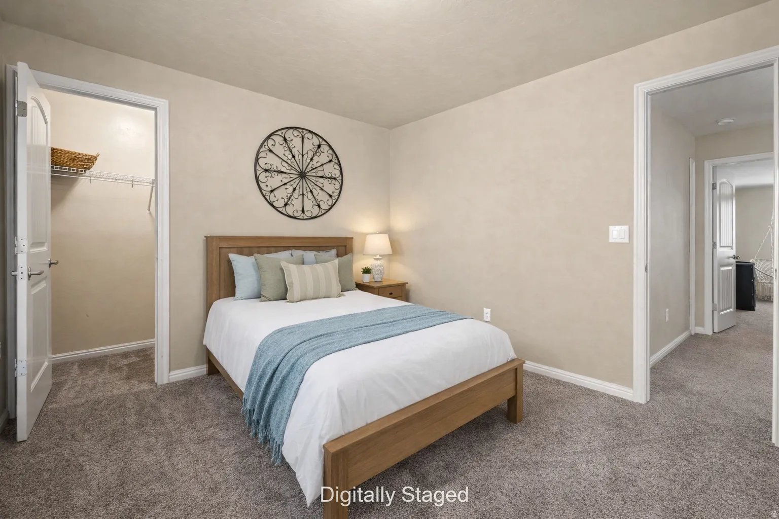 Digitally Staged, carpeted guest bedroom with a spacious closet