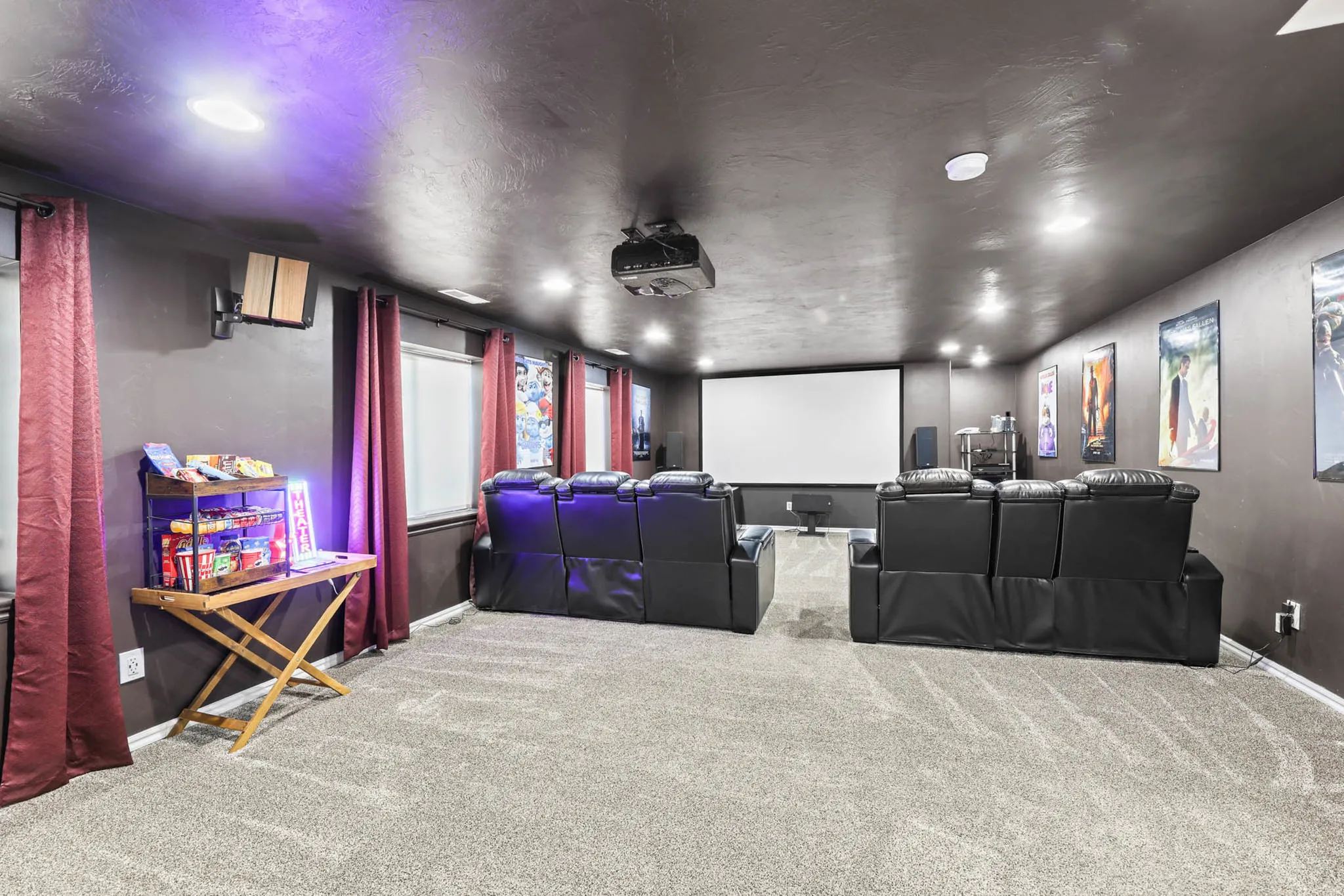 Home theater featuring light carpet and a textured ceiling