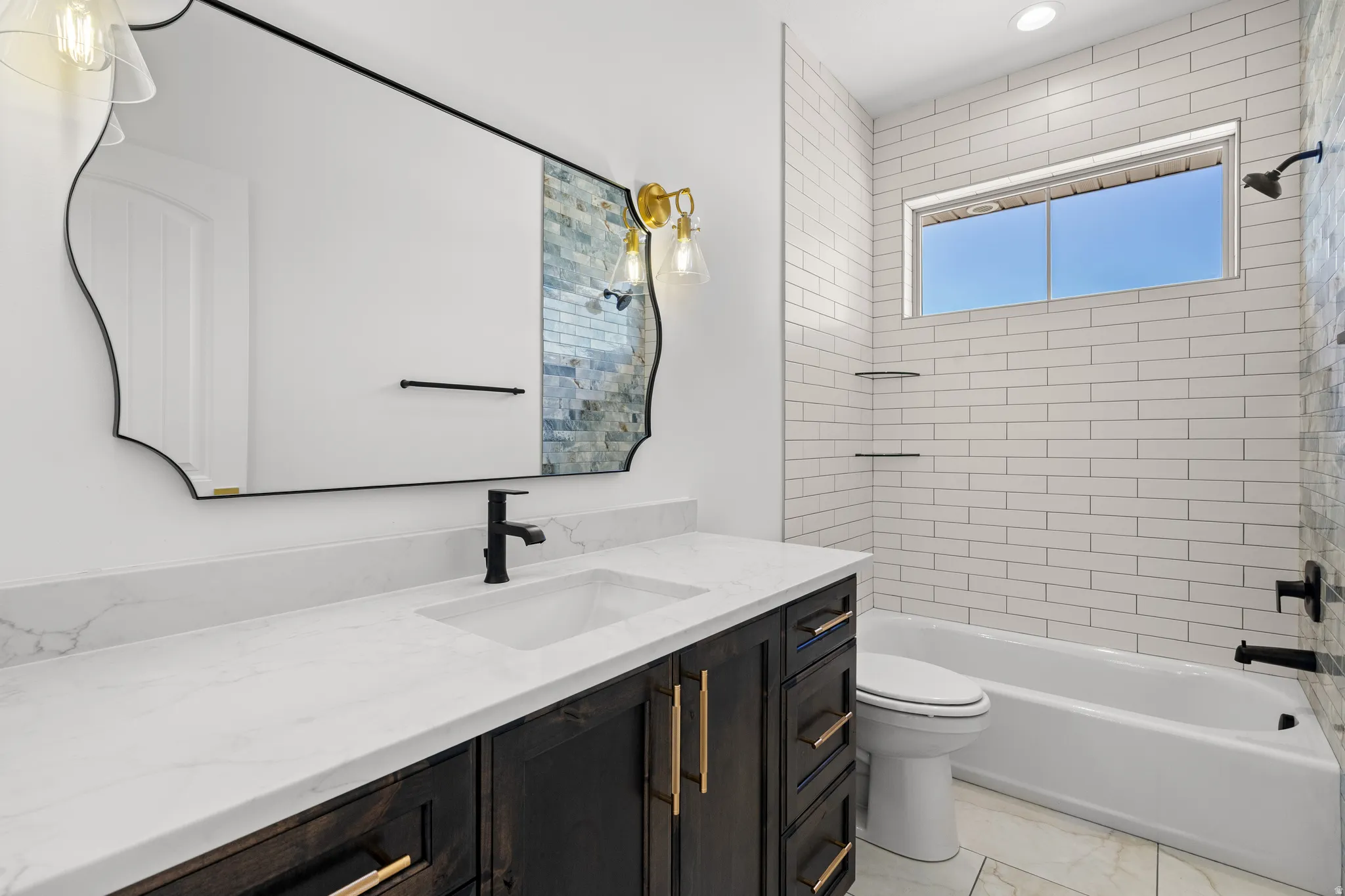 Bathroom with vanity and shower / bath combination