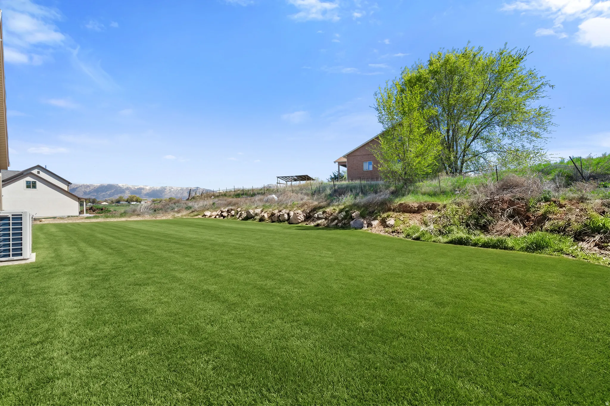 View of grassy yard featuring a mountain view