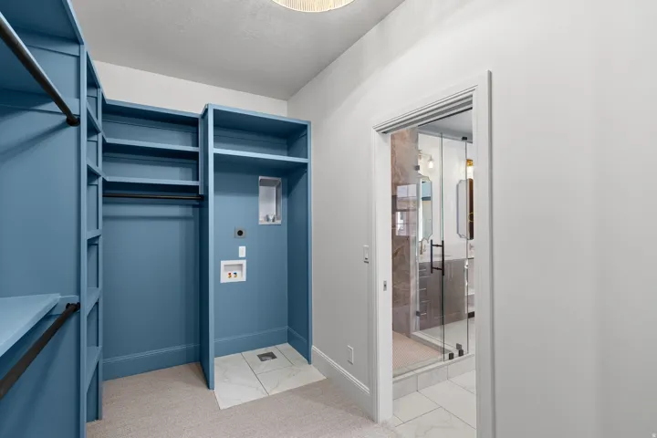 Walk in closet with light marble finish floors
