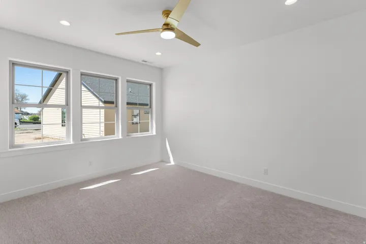 Empty room featuring carpet, ceiling fan, and recessed lighting