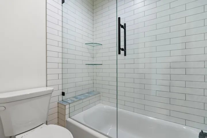 Bathroom featuring toilet and enclosed tub / shower combo