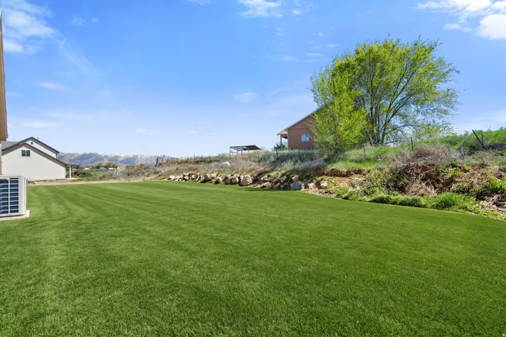 View of grassy yard featuring a mountain view