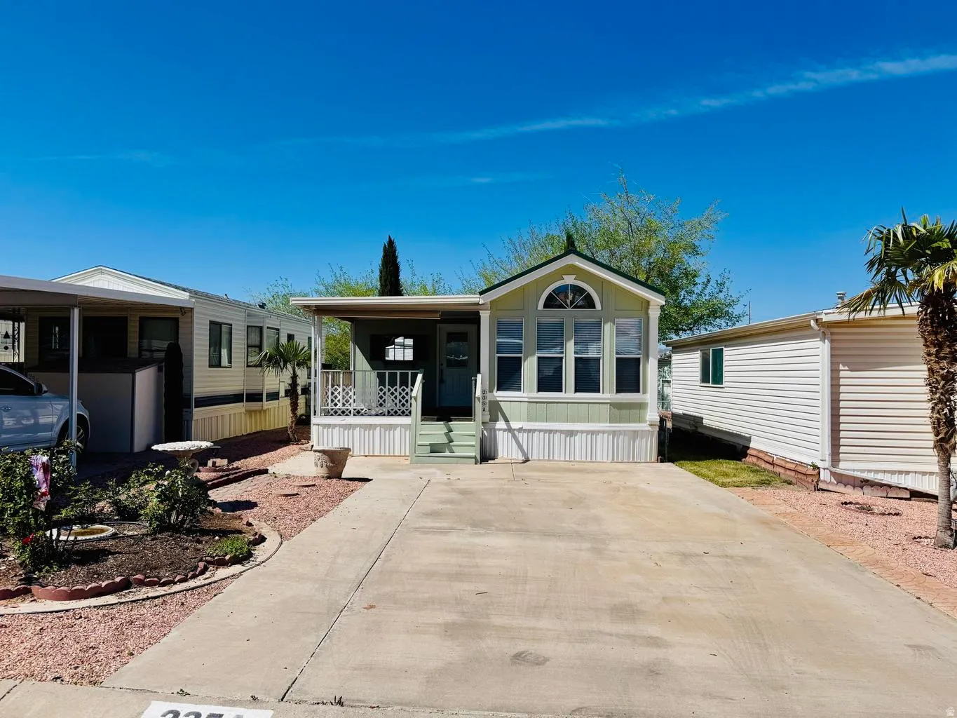Manufactured / mobile home featuring a porch and driveway