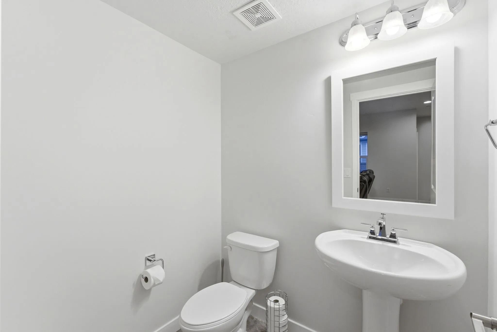 Half Bathroom featuring toilet and baseboards