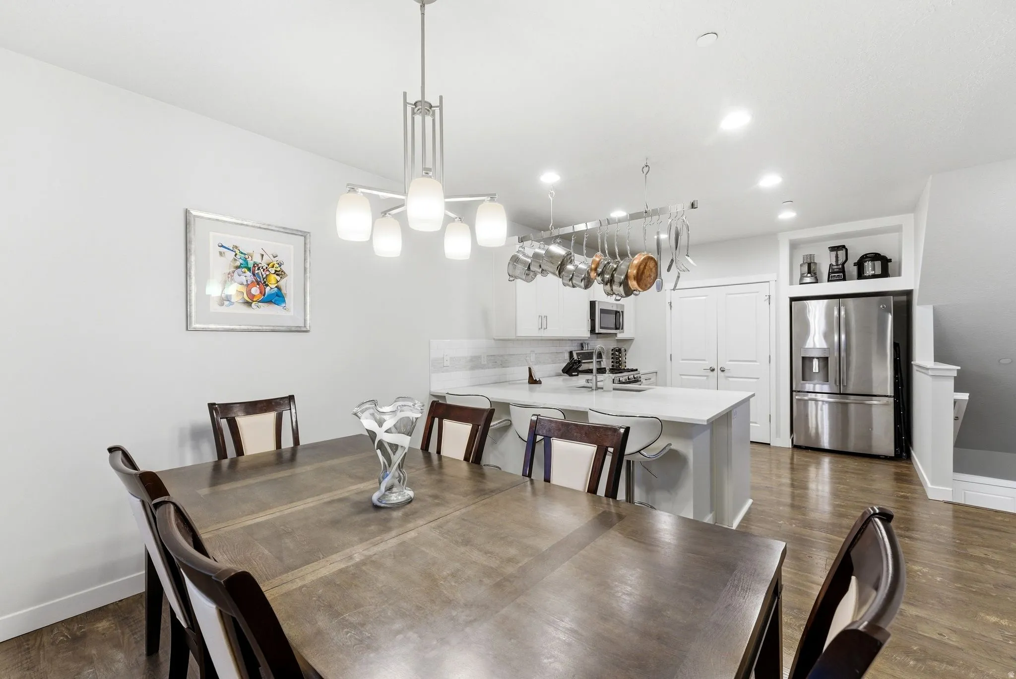 Dining room featuring dark wood-style floors and recessed lighting