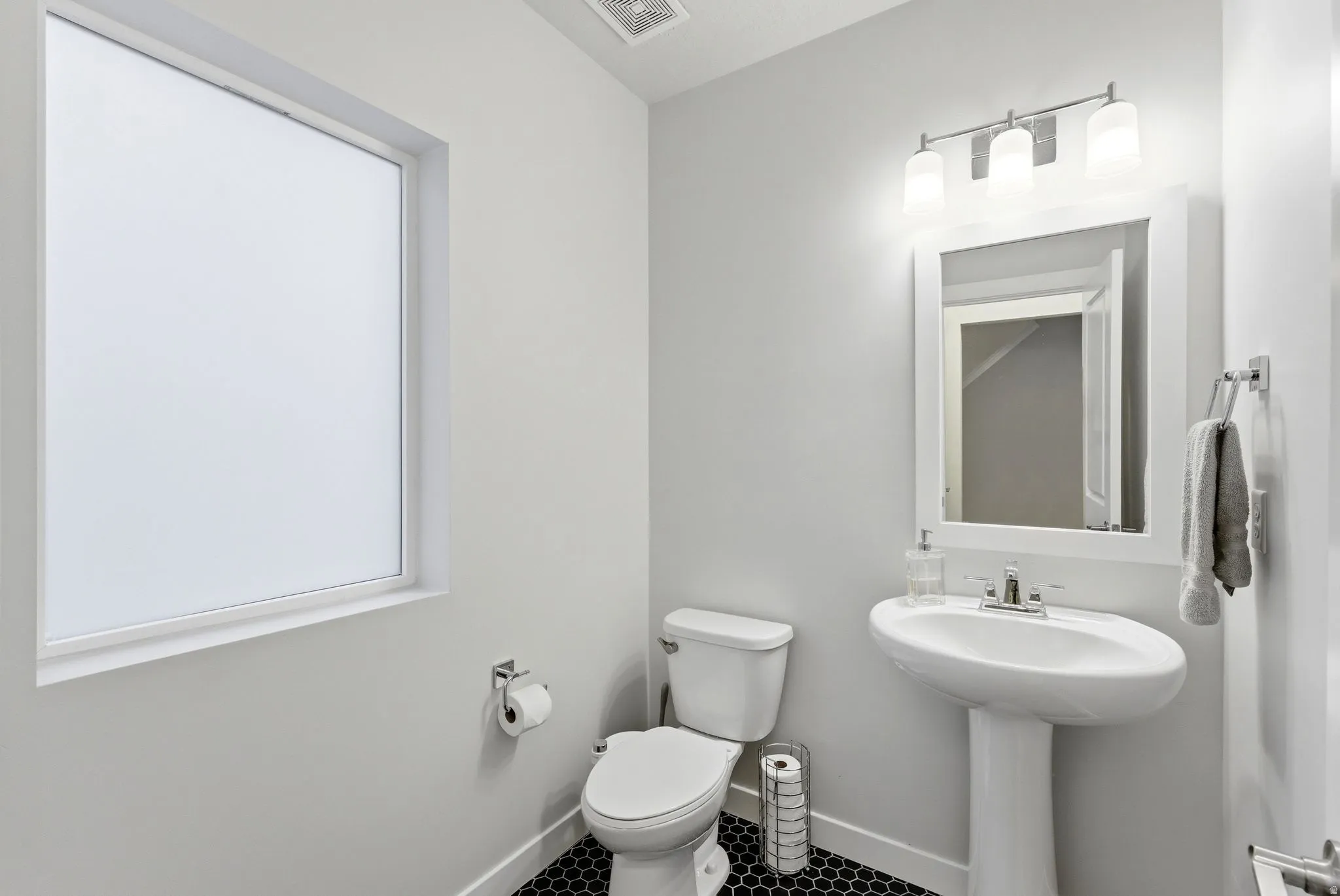Half Bathroom featuring toilet and tile patterned flooring