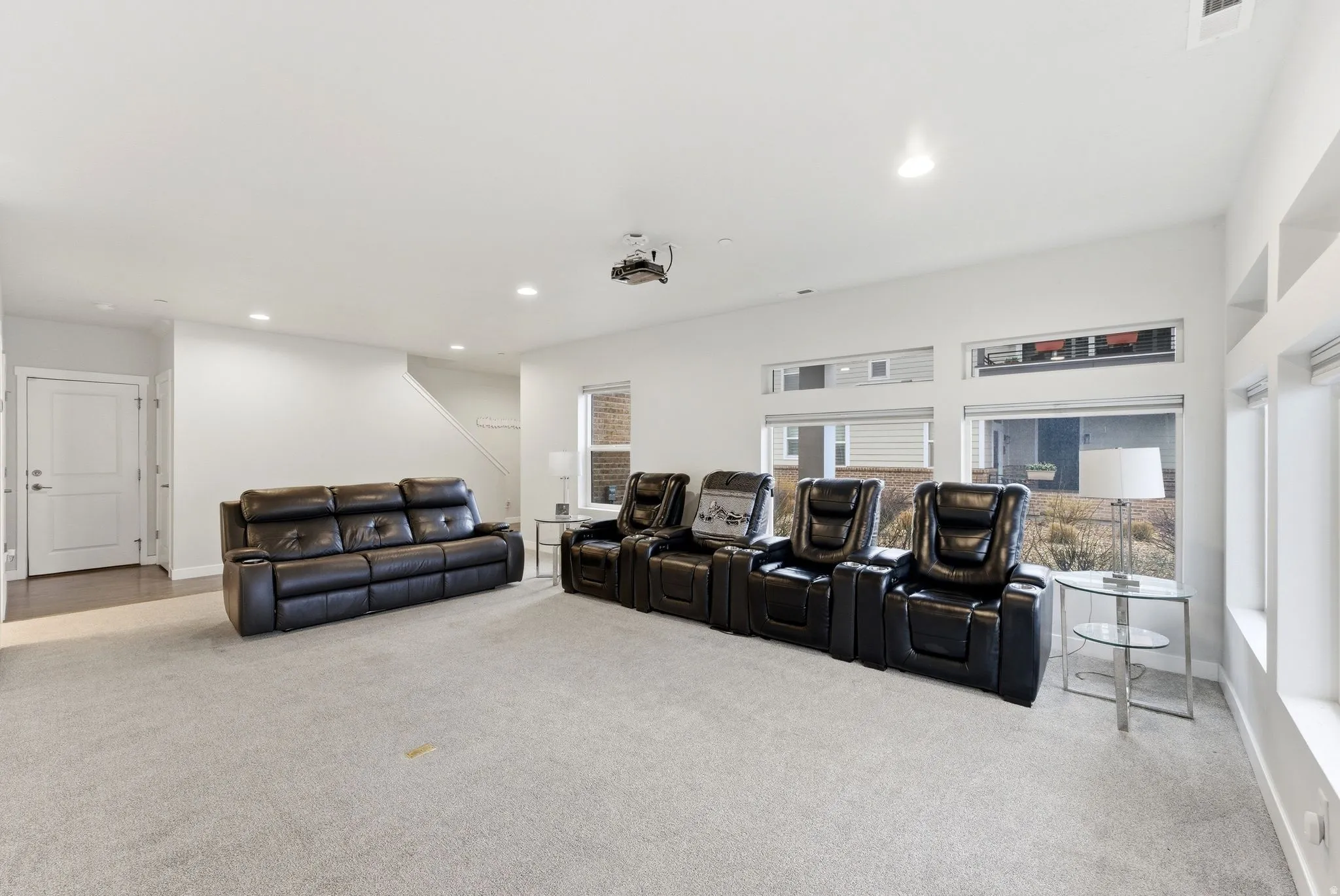 Home theater with light carpet and recessed lighting