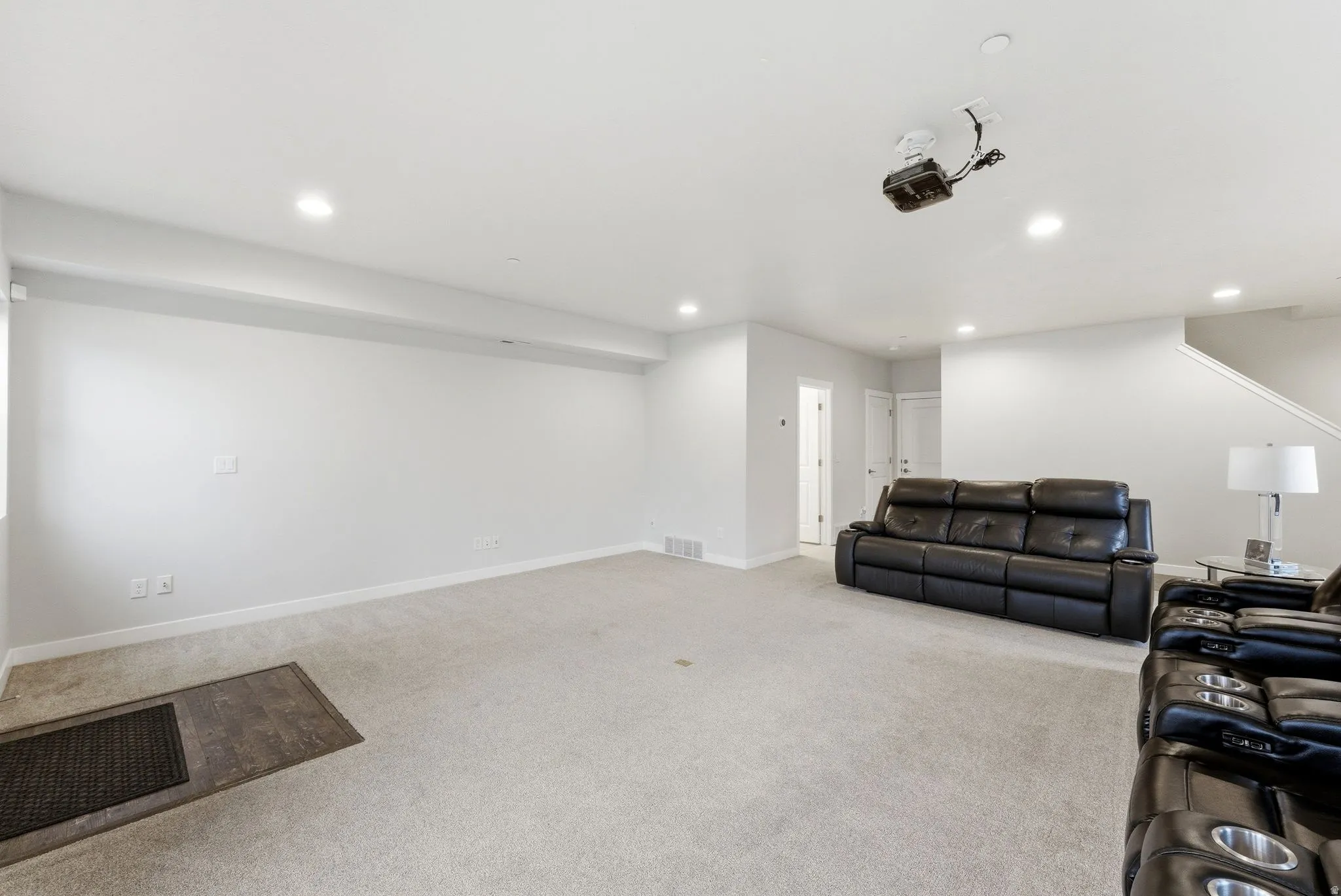 Living room with light carpet and recessed lighting