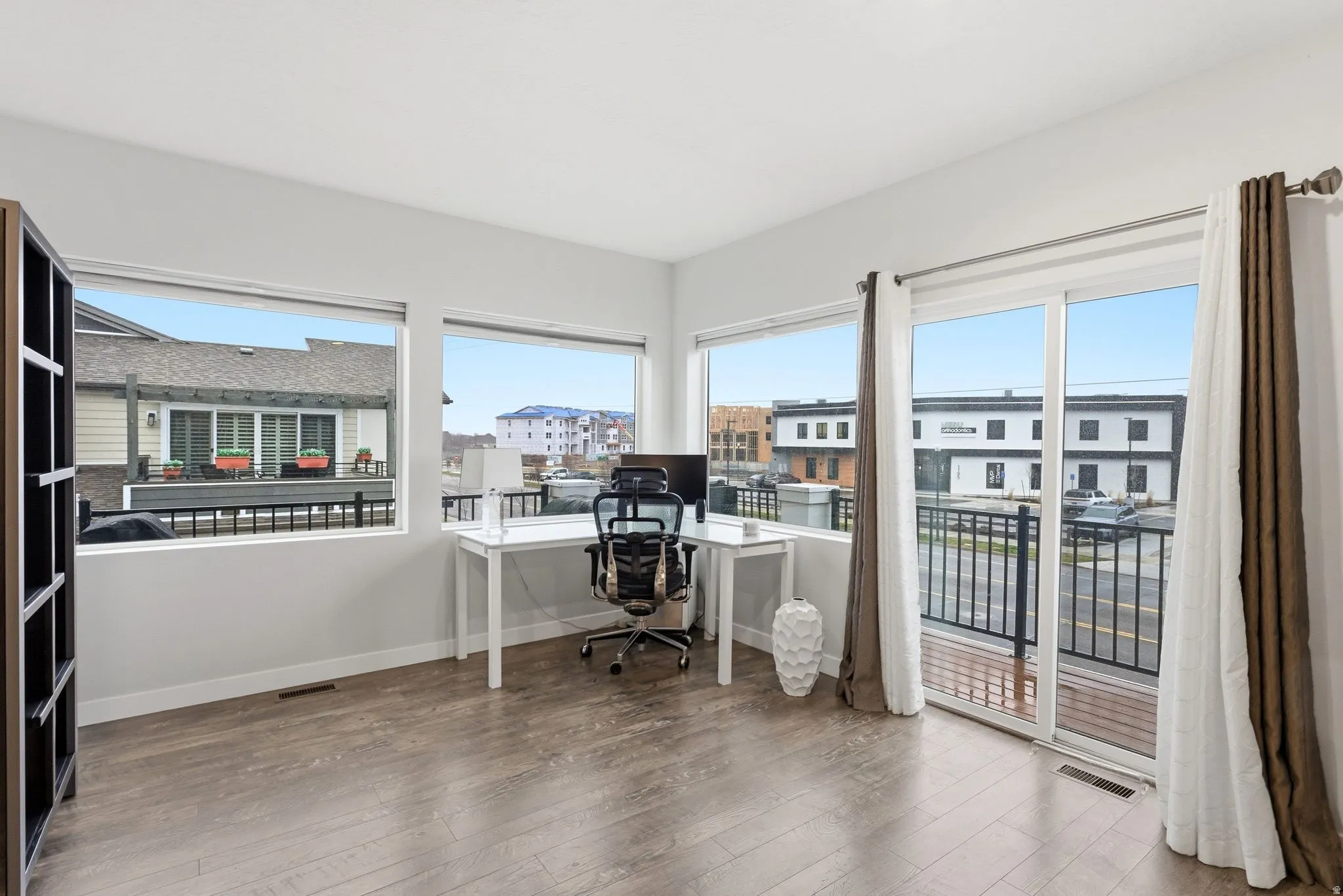 Office area with healthy amount of natural light and light wood-style floors