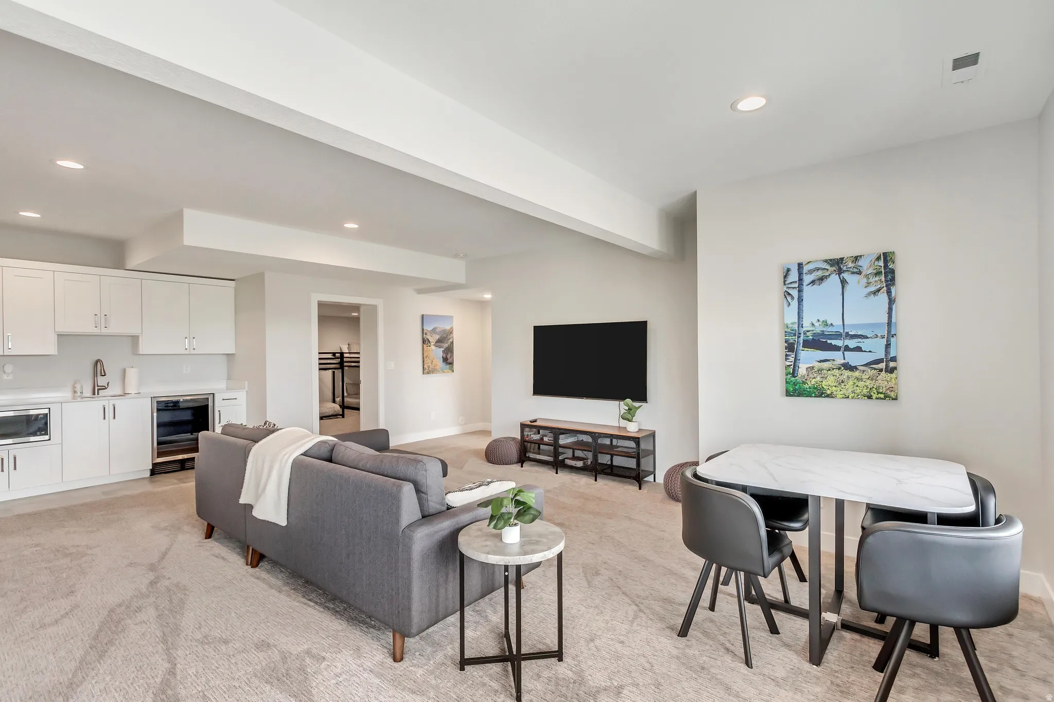 Living area with recessed lighting, beverage cooler, and light colored carpet