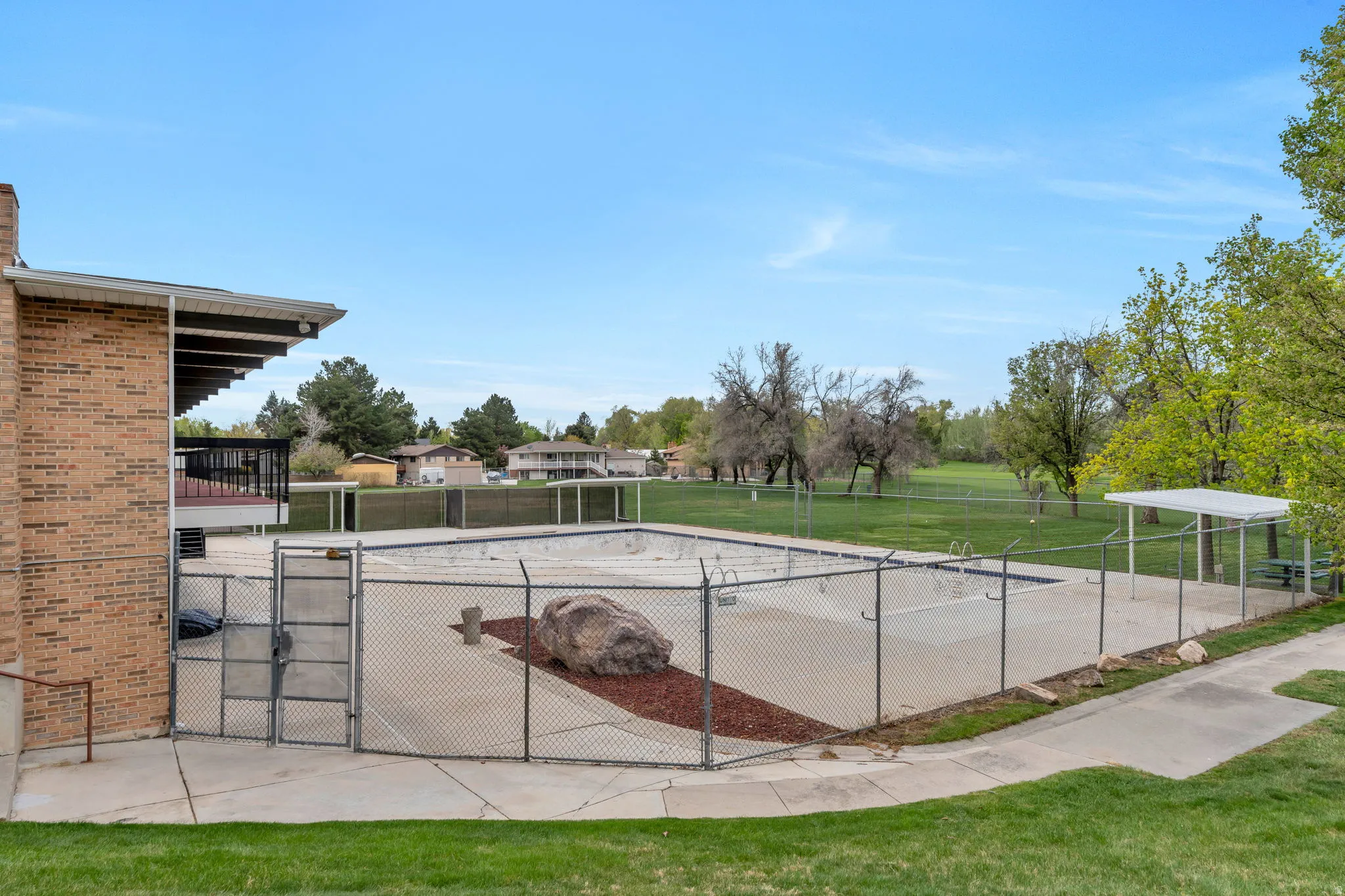 Surrounding community featuring a gate and a balcony