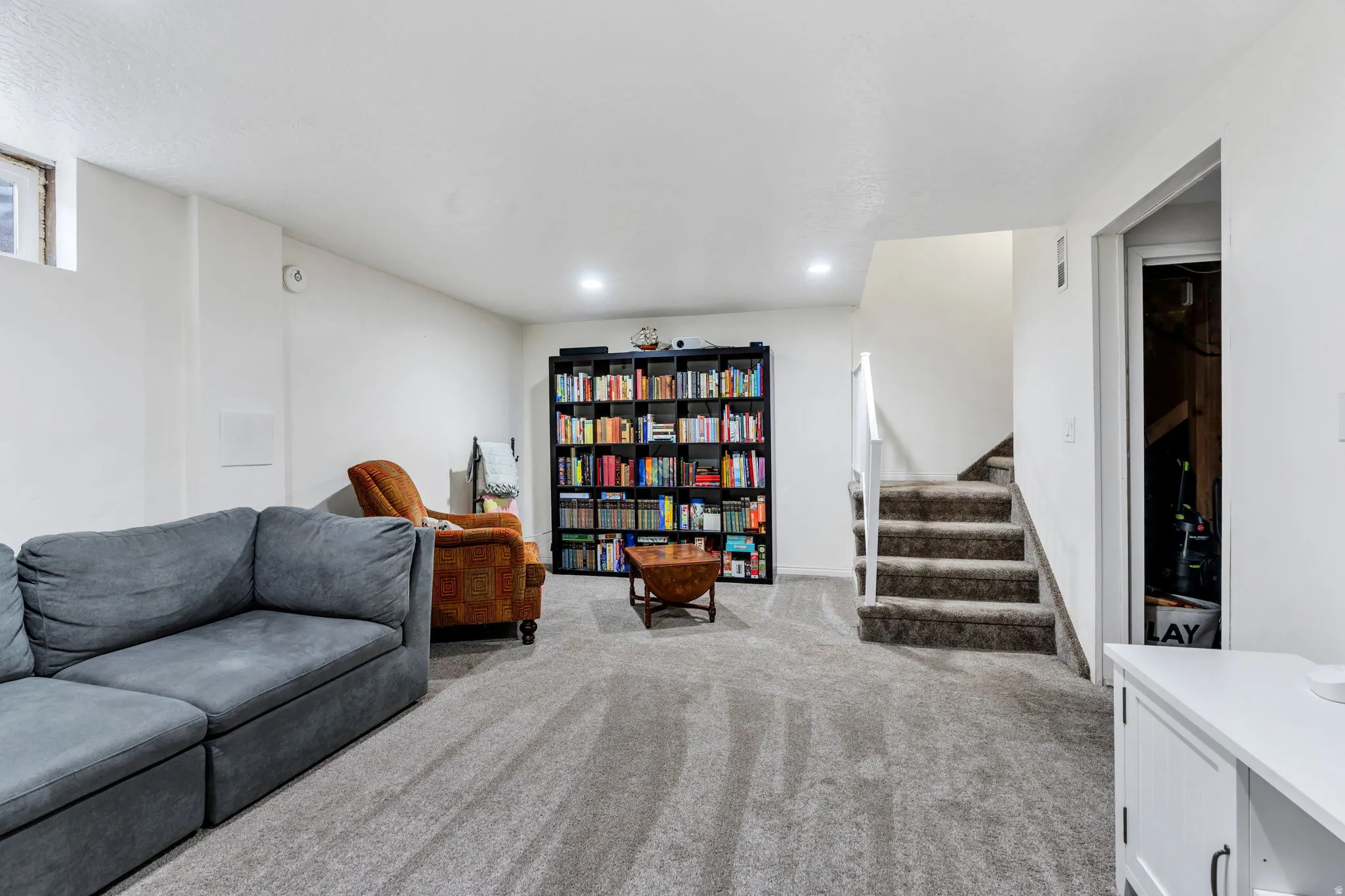 Living area with carpet floors and recessed lighting