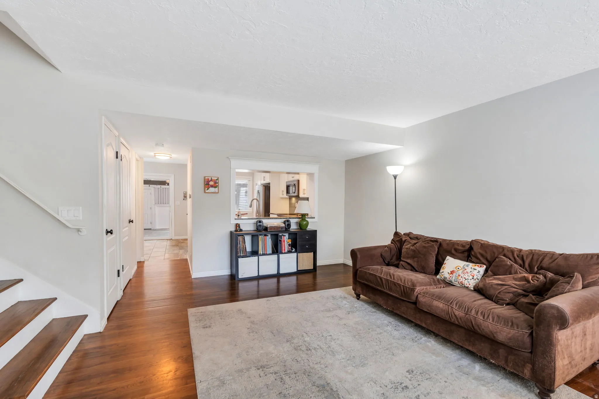 Living room featuring dark wood finished floors and a textured ceiling