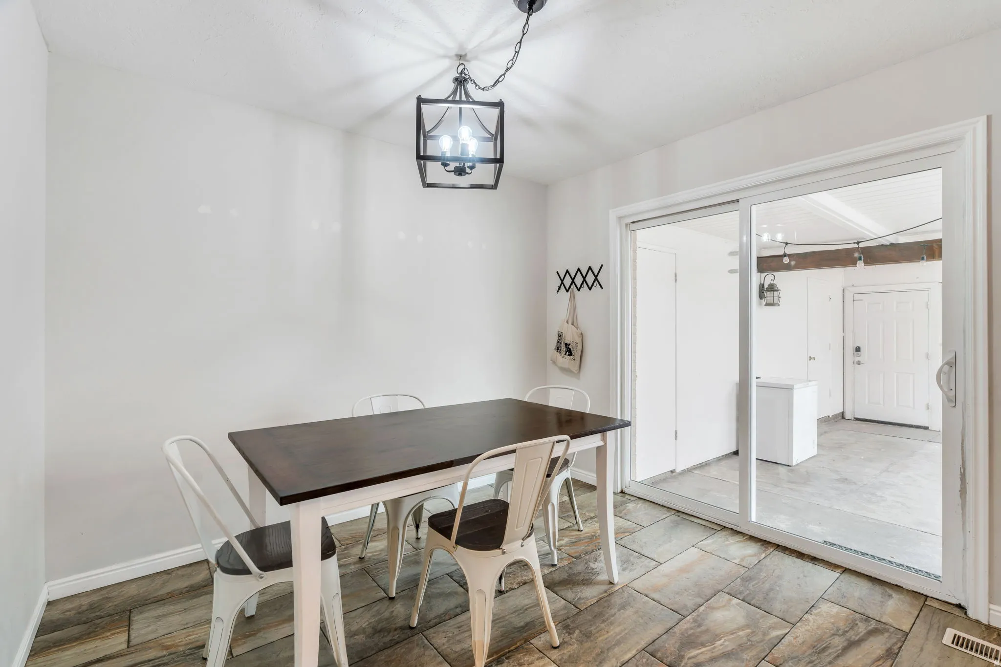 Dining room featuring hanging lights and wood tiled floors