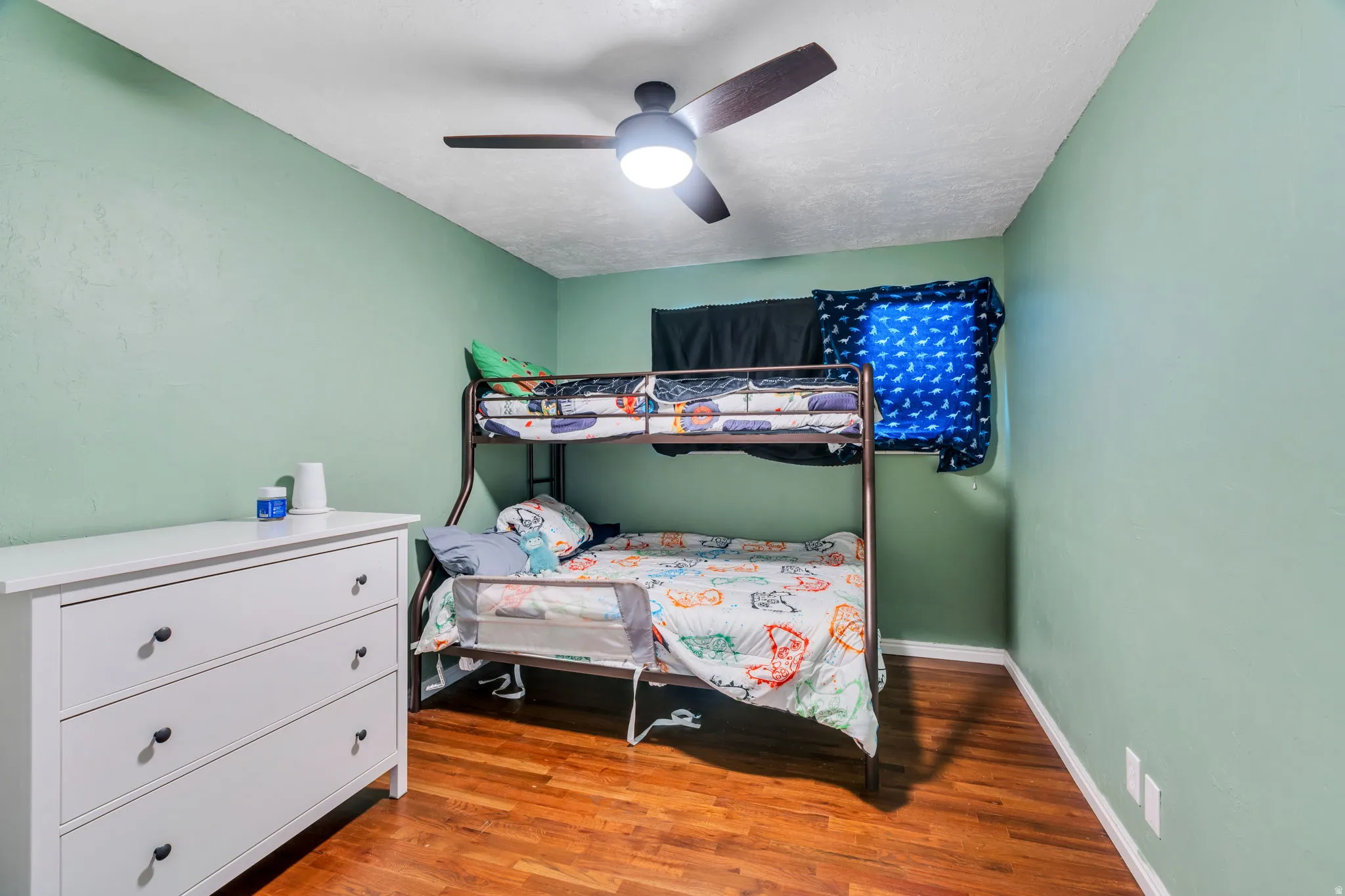 Bedroom featuring light wood-style floors and ceiling fan