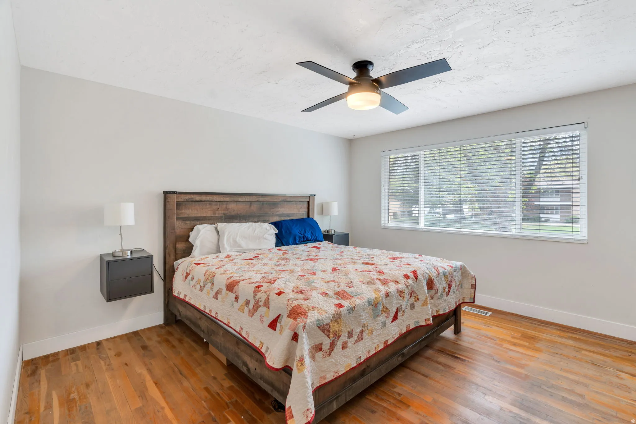 Bedroom featuring wood-type flooring and a ceiling fan