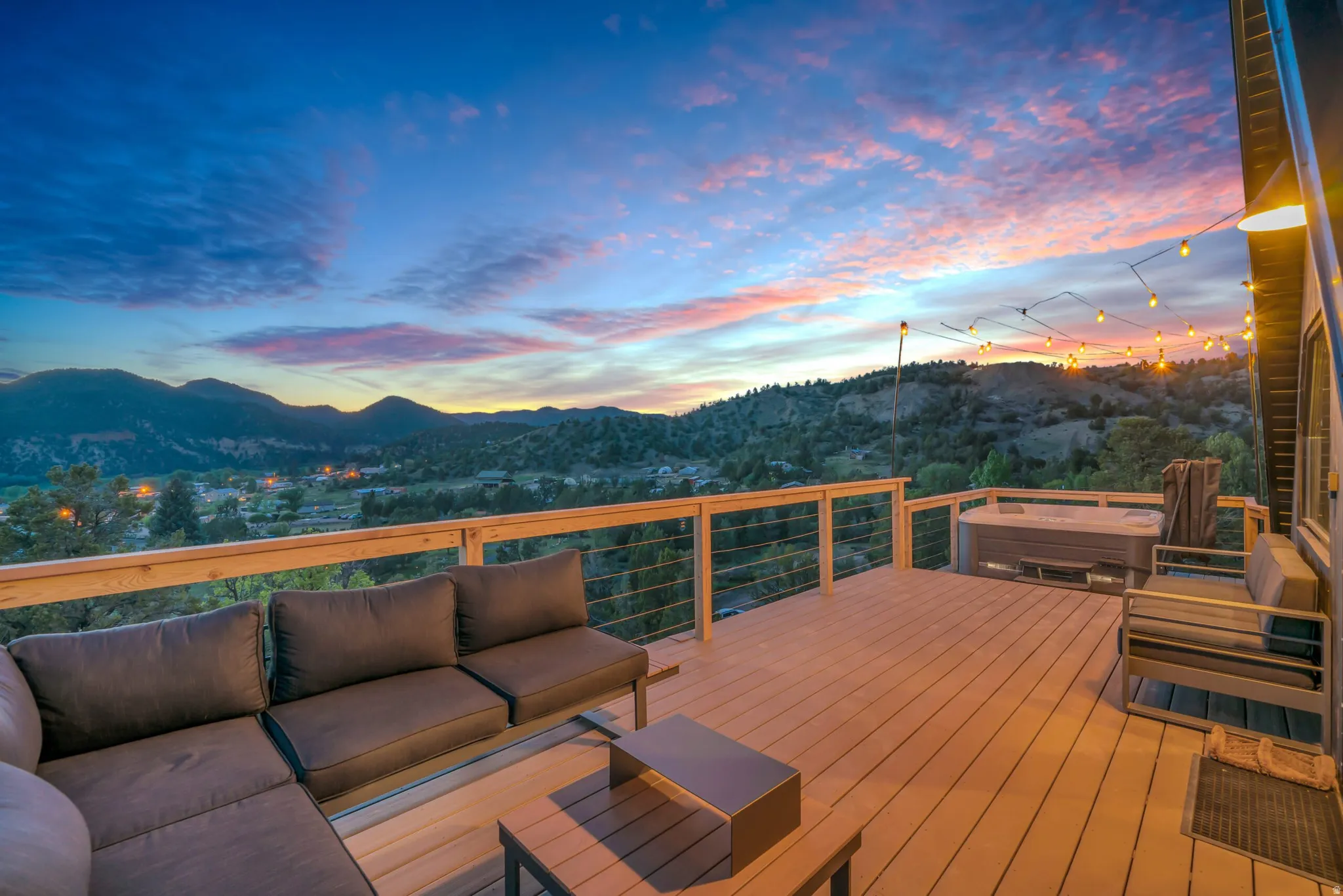 Wooden terrace featuring a mountain view and an outdoor hangout area