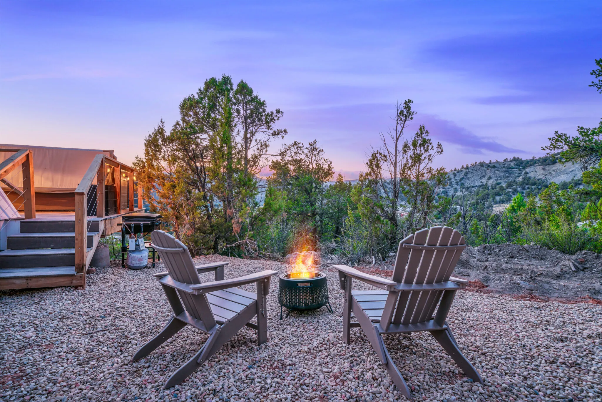 Yard at dusk with an outdoor fire pit and a patio