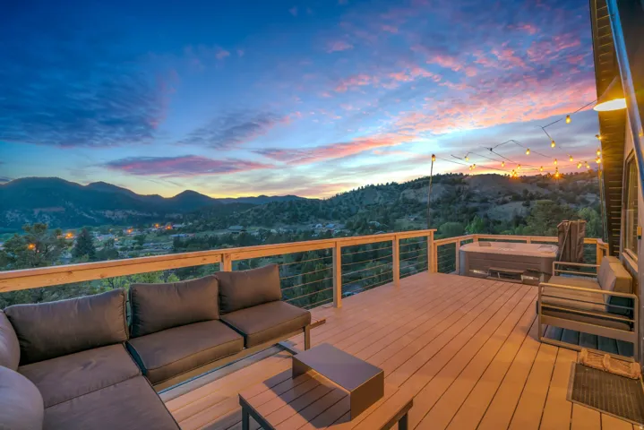 Wooden terrace featuring a mountain view and an outdoor hangout area